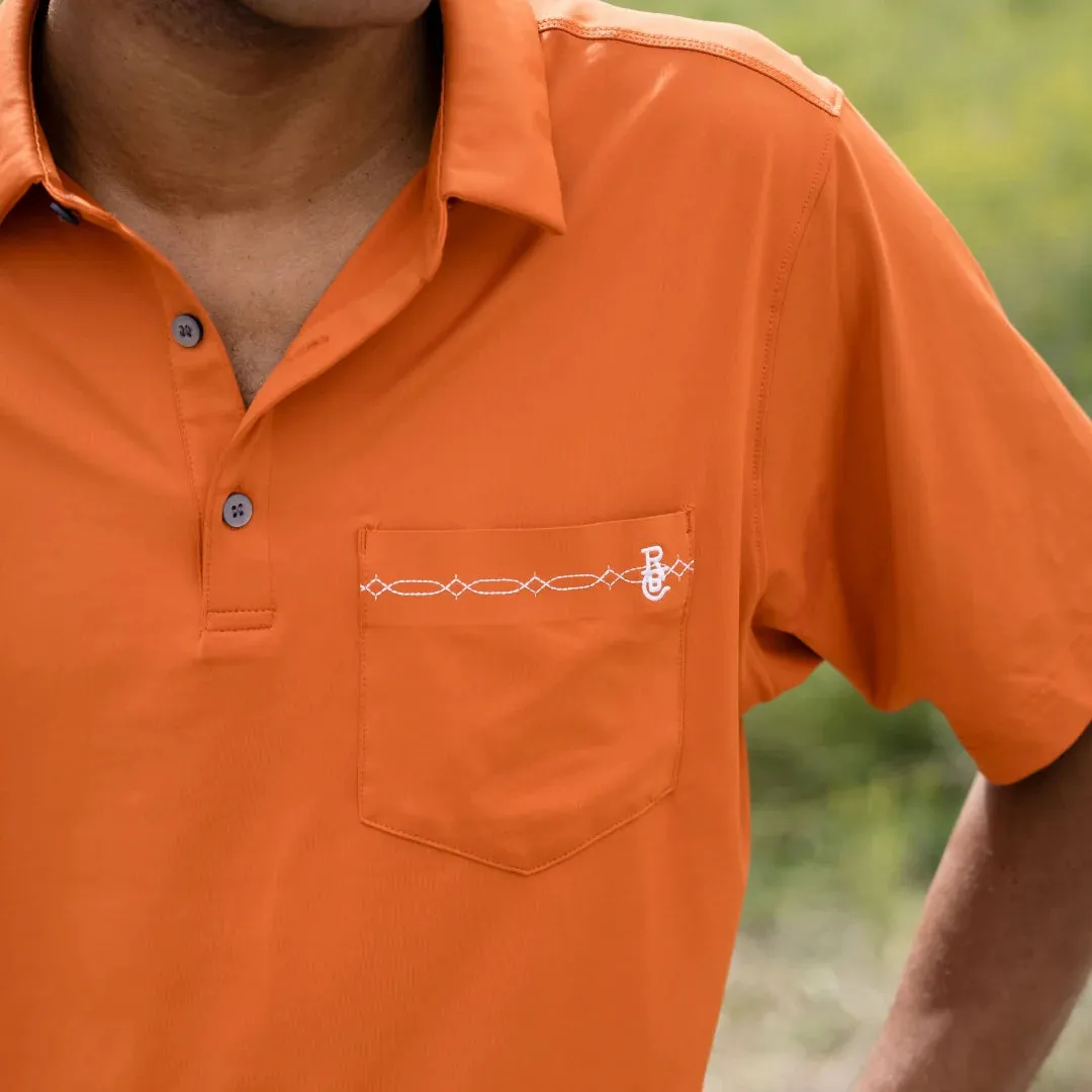 Raised by Coyotes Texas Orange Bootstitch Pocket Polo